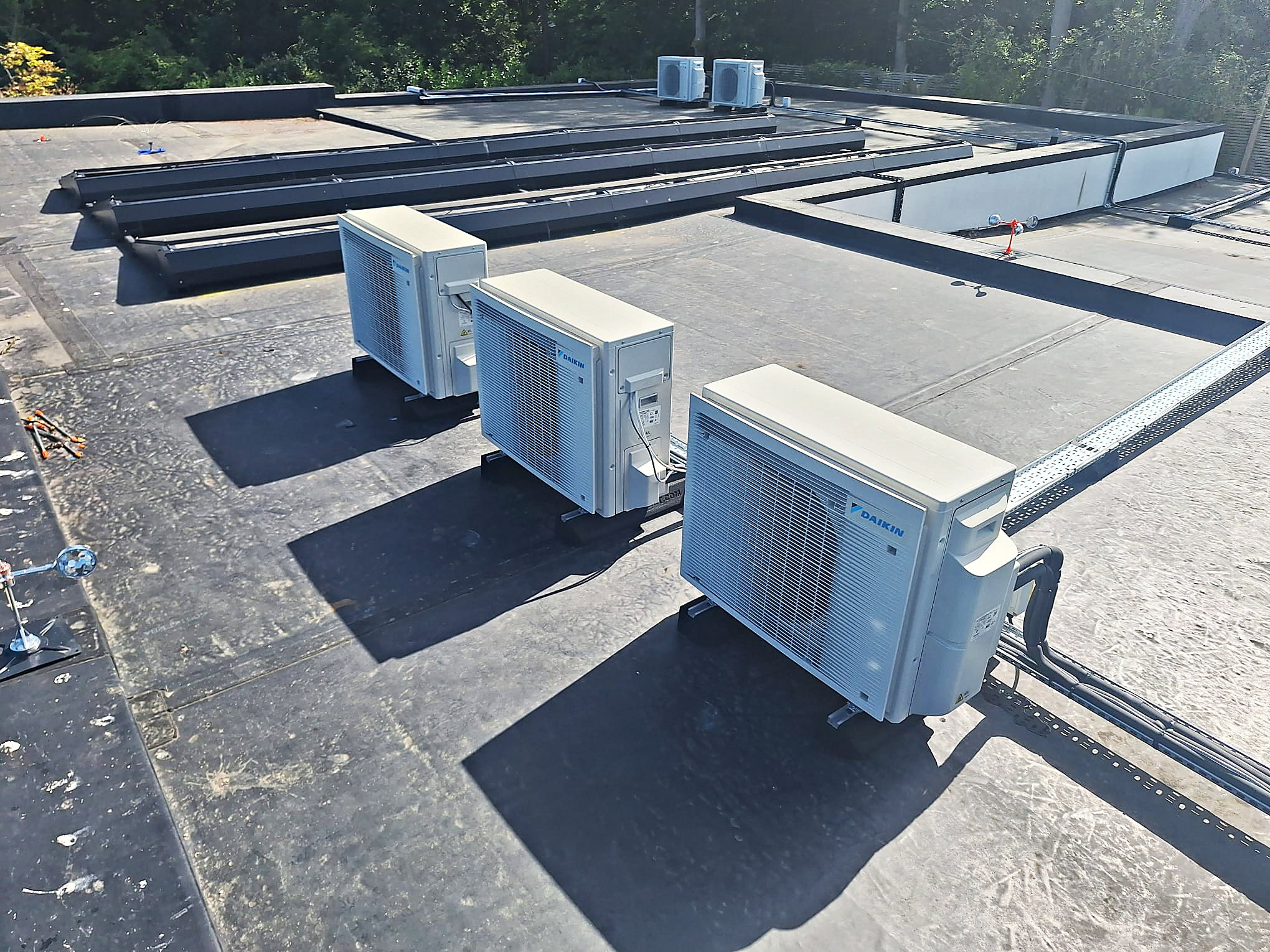 Daikin condenser units installed together on a flat roof