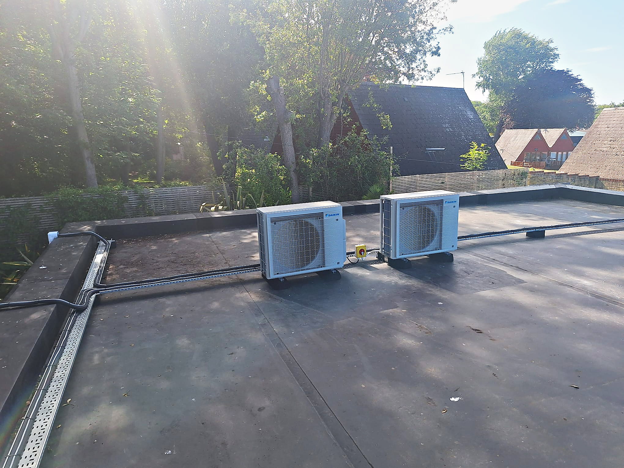 Two Daikin condenser units installed on a flat roof