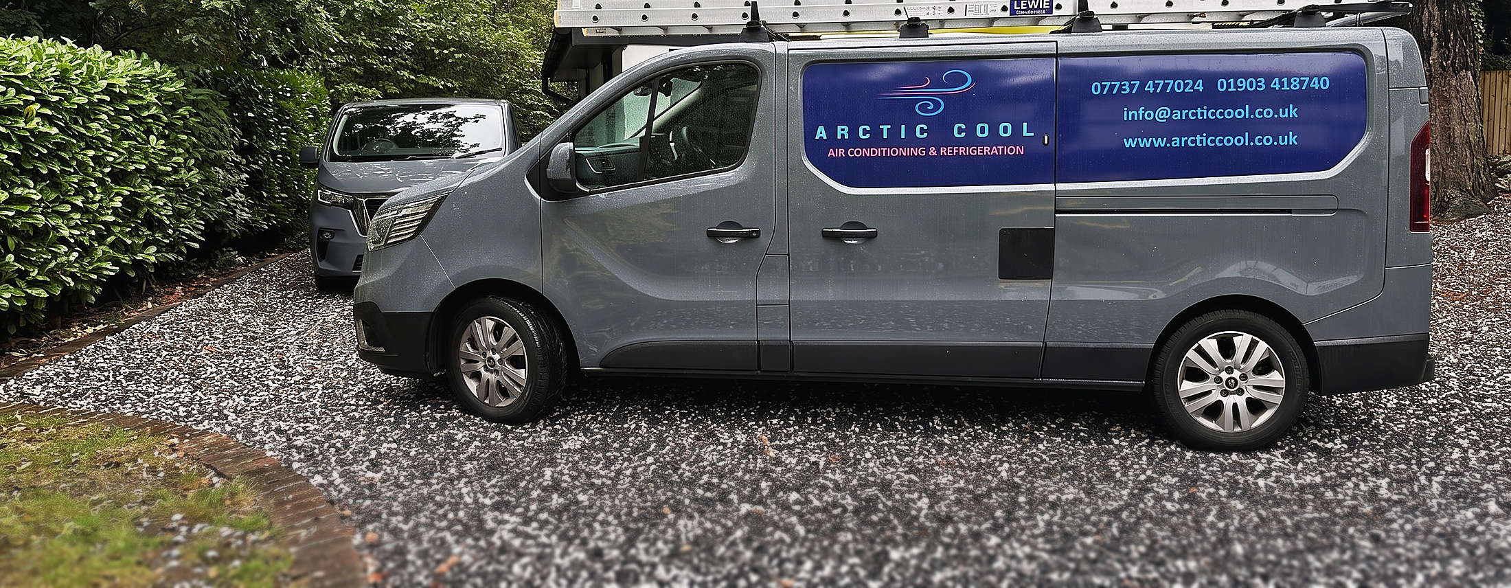 An Arctic Cool van with the company name and telephone numbers on the side
