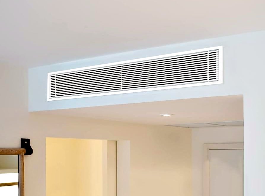Long slimline ducted grille set into the ceiling above a doorway