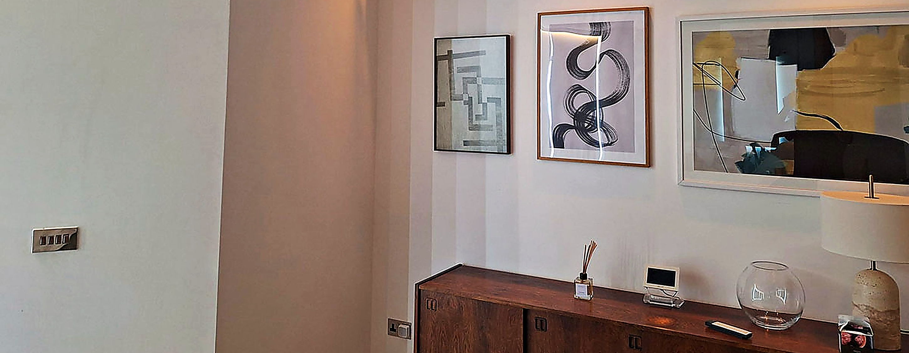 Wall mounted unit in a living room hung with pictures