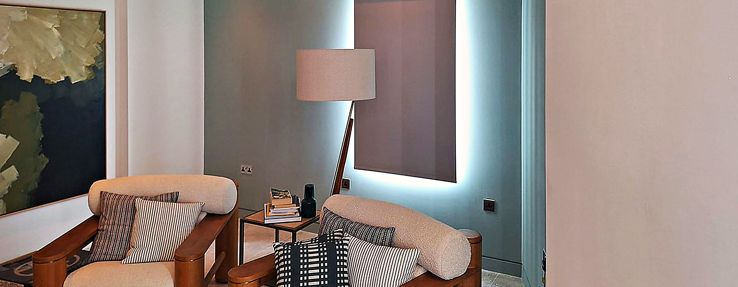 Wall mounted unit above the window of a teal painted sitting room