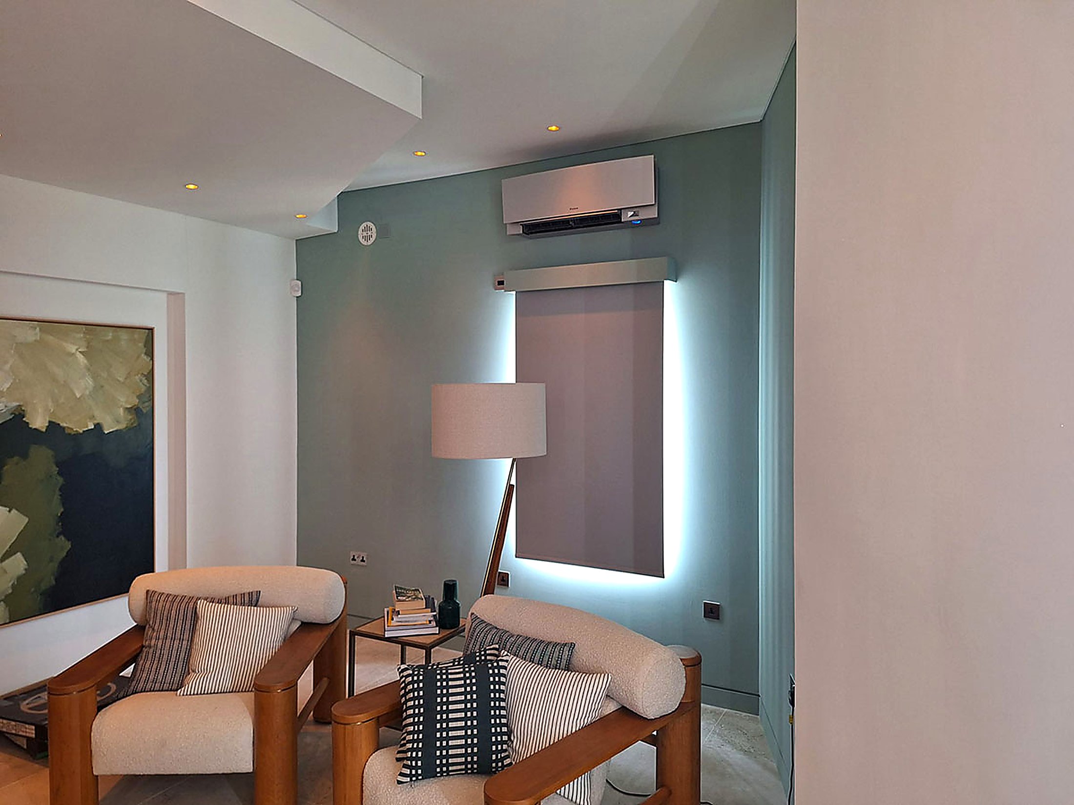 Unit fitted above a window in a teal painted sitting room