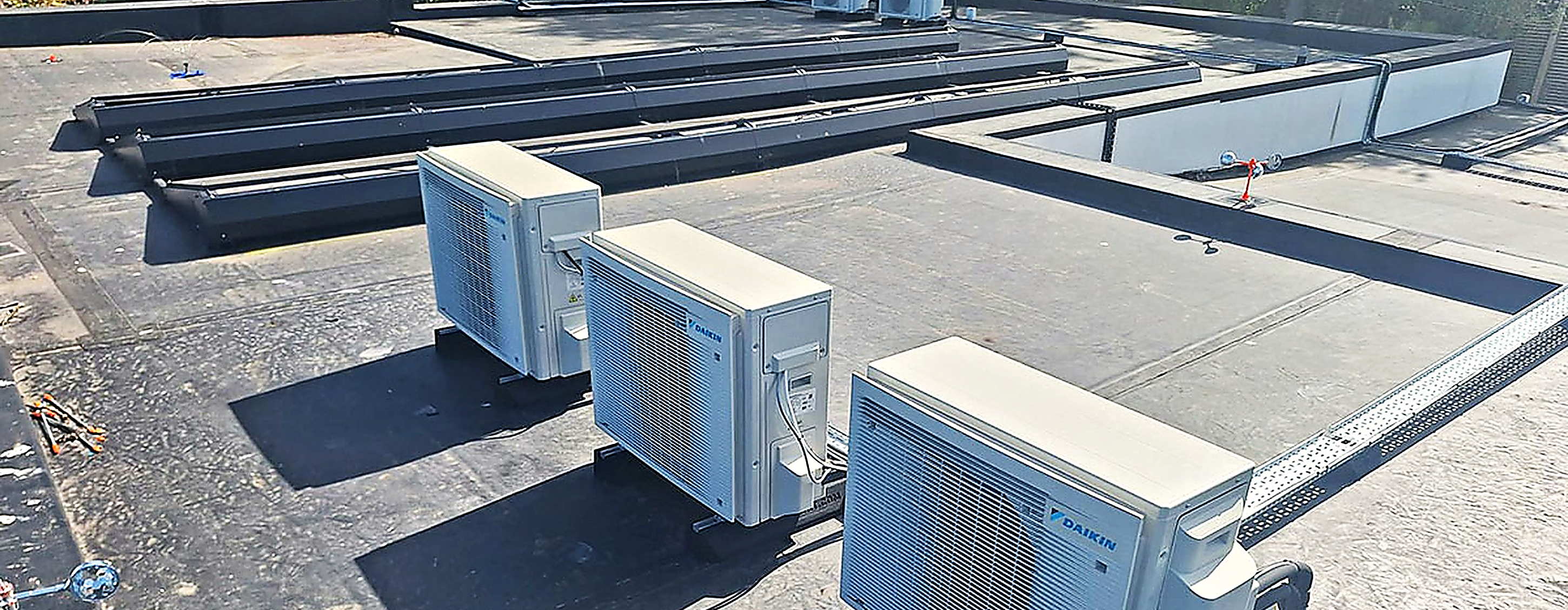 Four Daikin condenser units installed on a commercial flat roof